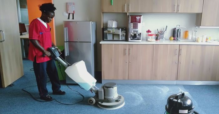 Cleaner cleaning a glass window and frame