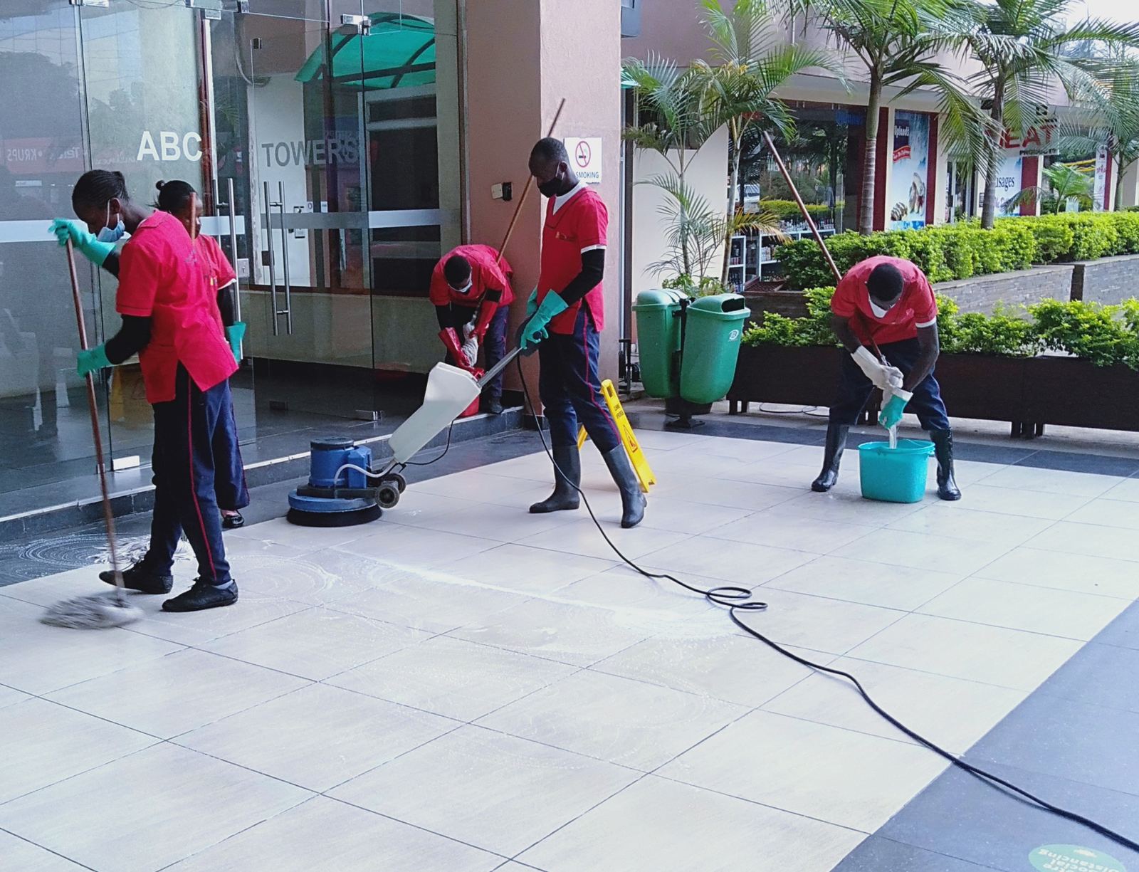 Steps Ahead cleaning team polishing the plaza floor outside ABC Towers, Nairobi